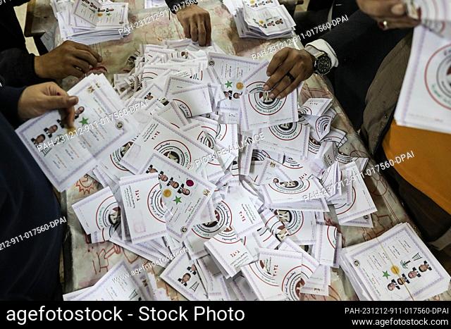 12 December 2023, Egypt, Cairo: Egyptian electoral workers count ballots at a polling station in Shoubra Secondary School For Boys at the end of the last day of...