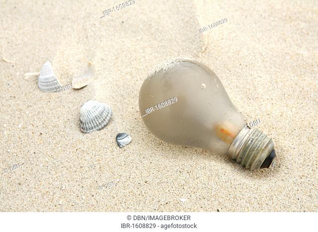 Old light bulb in the sand