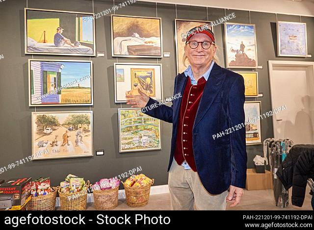 01 December 2022, Hamburg: Otto Waalkes, comedian and painter, stands in front of a wall of his paintings after an interview