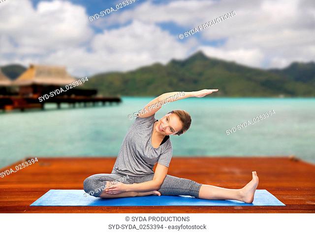 happy woman making yoga and stretching outdoors