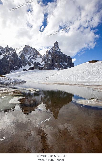 Thawing snow leaving some puddles at the foot of the Pale di San Martino by San Martino di Castrozza, Dolomites, Trentino, Italy, Europe
