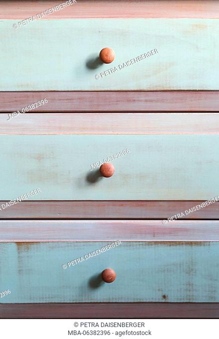 Chest of drawers, drawers, pastel background with wooden buttons