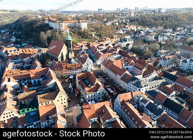 PRODUCTION - 12 December 2023, Saxony, Pirna: View of Pirna's old town with the town hall (front) and St. Mary's Church (aerial view with a drone)