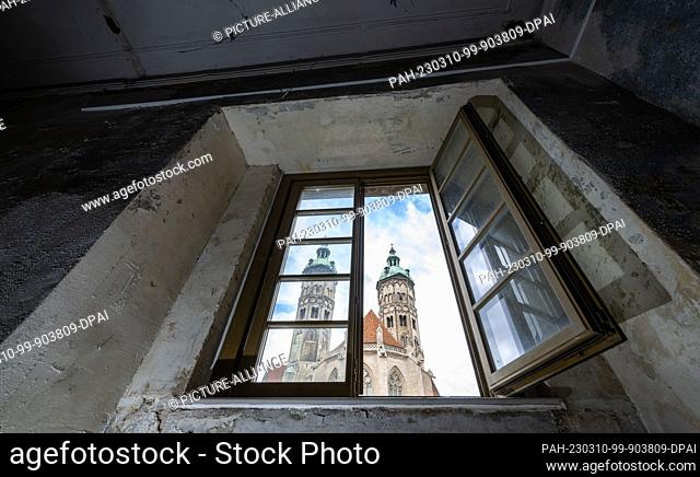 10 March 2023, Saxony-Anhalt, Naumburg: The towers of the cathedral in Naumburg can be seen through a window of the former bishop's curia