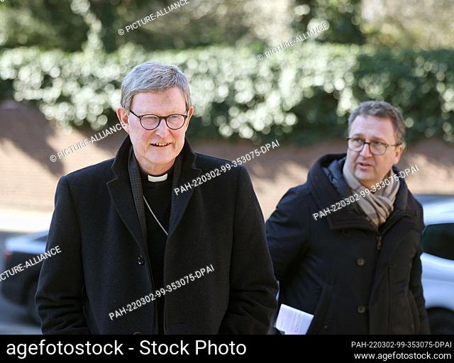 02 March 2022, North Rhine-Westphalia, Cologne: Cardinal Rainer Maria Woelki (l), accompanied by a reporter, leaves the Archbishop's House for an Ash Wednesday...