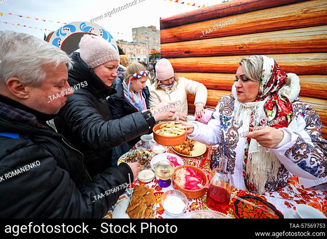 RUSSIA, ROSTOV REGION - FEBRUARY 26, 2023: Citizens approach a food stall during a celebration of Maslenitsa [Pancake Week] in Petrovskaya Square, Azov