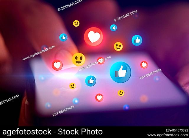 Finger touching phone with social media concept and dark background