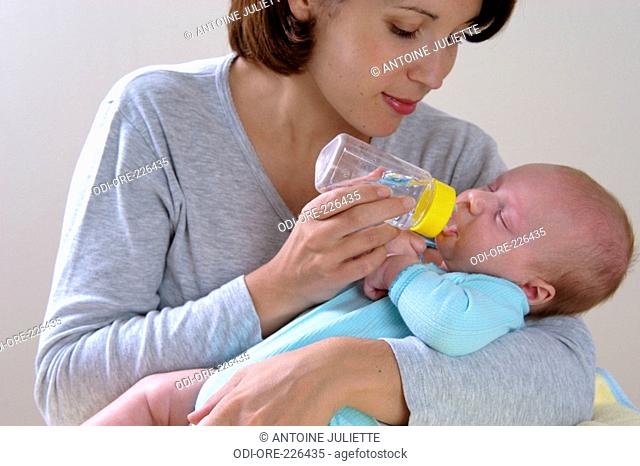 Woman baby feed bottle