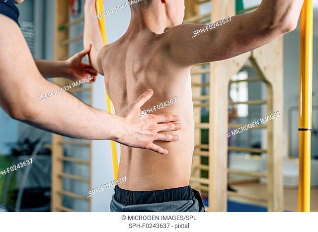 Physical therapist with teenage boy