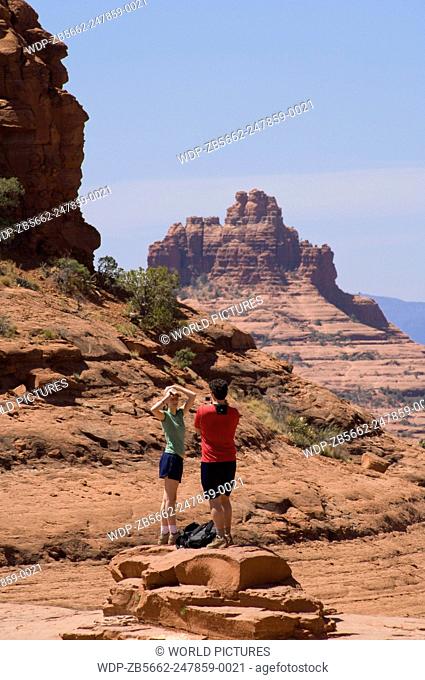Couple hiking on Broken Arrow Trail at Chicken Point, Sedona, Arizona