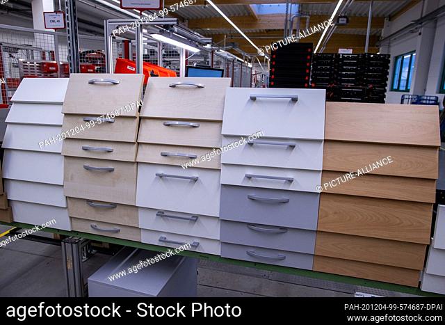 25 November 2020, Mecklenburg-Western Pomerania, Schönberg: Drawers for desk pedestals are located on one of the production lines of the office furniture...