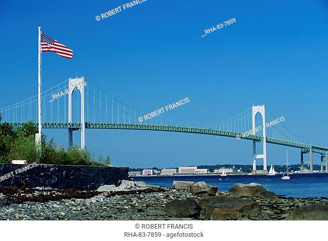 The Stars and Stripes flying before the Newport Bridge, connecting Jamestown, Conanicut Island, and Aquidneck Island, Rhode Island, New England