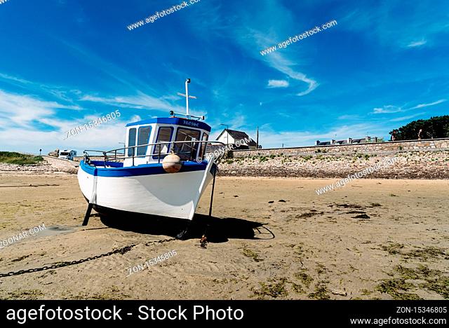 Plouguerneau, France - August 1, 2018: Stranded ships at low tide in the beach of Kervenni in Pointe du Castel Ac'h. Sunny day of summer