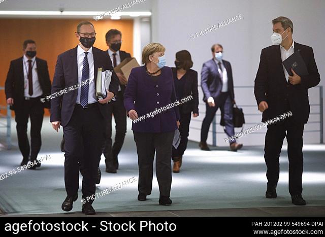 02 December 2020, Berlin: German Chancellor Angela Merkel (CDU, M), Michael Müller (SPD, l), Governing Mayor of Berlin, and Markus Söder (r, CSU)