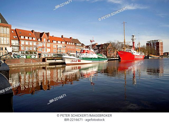Museum ships are reflected in the water of the Ratsdelft in the harbour of Emden, East Frisia, Lower Saxony, Germany