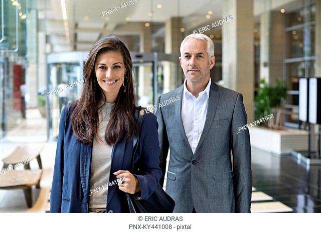Business couple standing in a hotel lobby