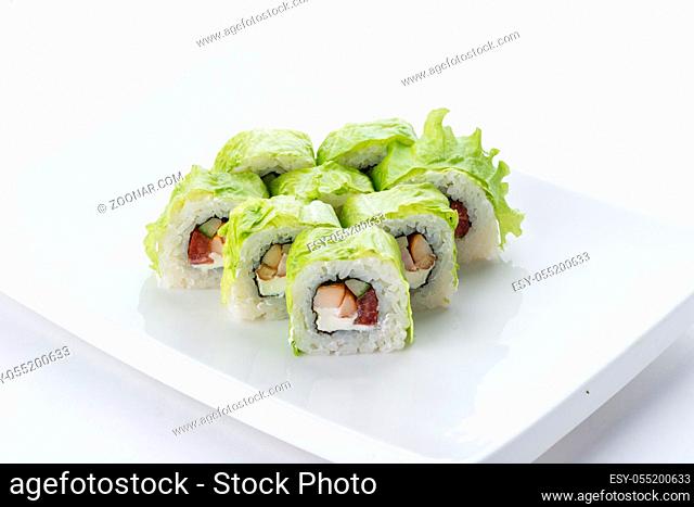 Sushi set and composition at white background. Japanese food restaurant, sushi maki gunkan roll plate or platter set
