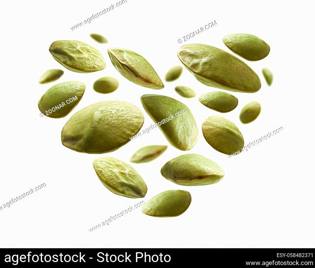 Green lentils in the shape of a heart on a white background