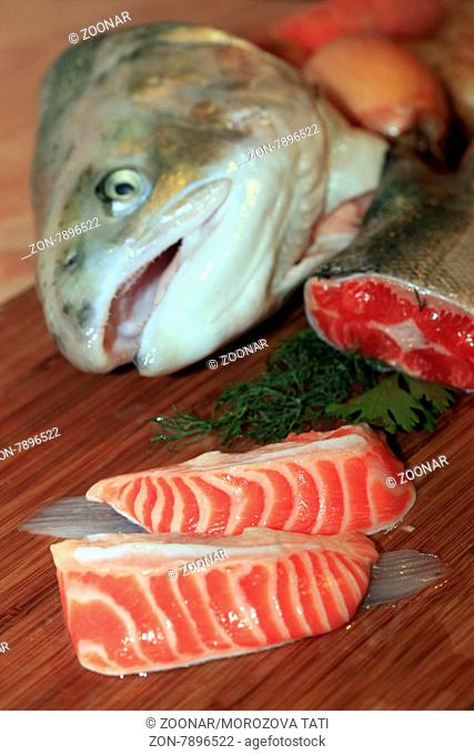 Fresh red salmon fish on wooden cooking desk