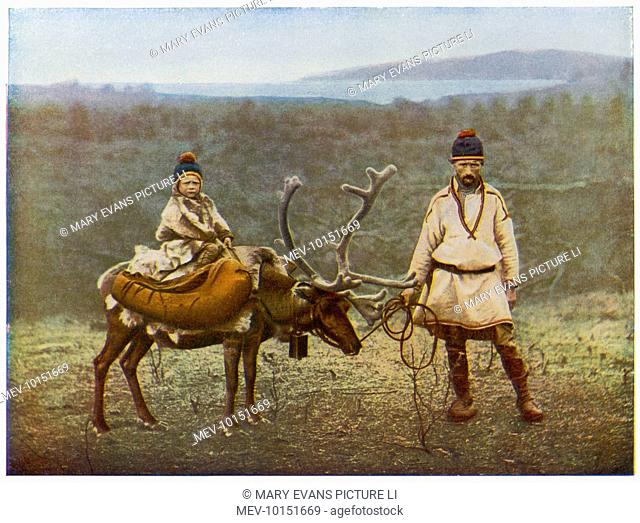 Lapp father and son, with a domesticated reindeer