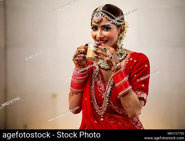 Indian Bride enjoying a cup of tea during her wedding