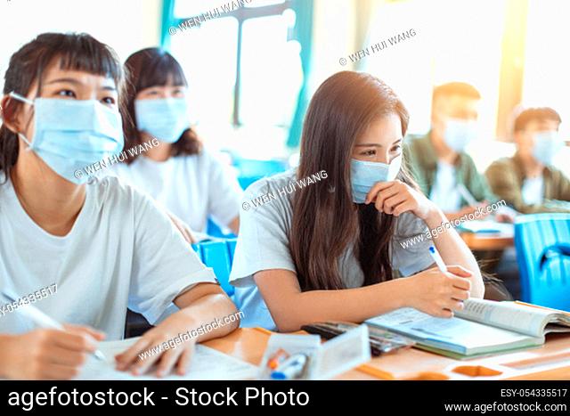 Students wearing protection mask to prevent germ, virus and PM 2.5 micron in classroom
