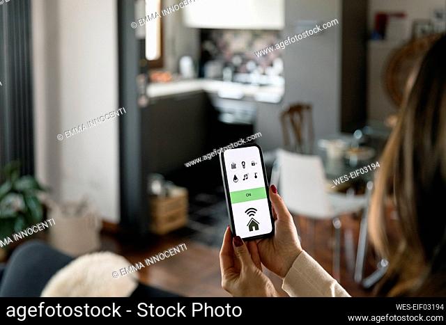 Woman using app on smart phone at home