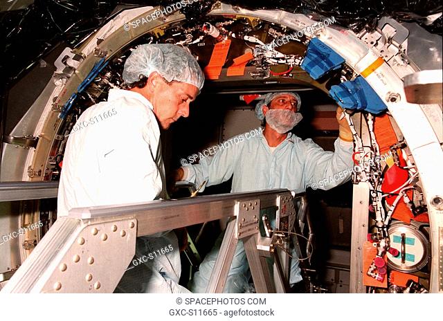 09/21/1998 --- Workers in the Space Station Processing Facility work in the doorway of the Unity connecting module preparing it for closure before its launch...