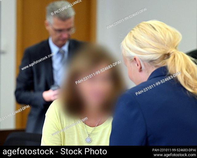 11 October 2023, Brandenburg, Potsdam: The accused managing director of Lunapharm Deutschland GmbH chats with her lawyer in Room 6 of the Potsdam Regional Court...