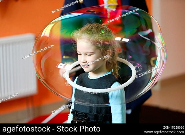 Little girl inside the soap bubble