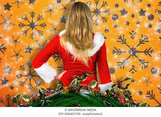 Composite image of pretty girl in santa outfit holding gift