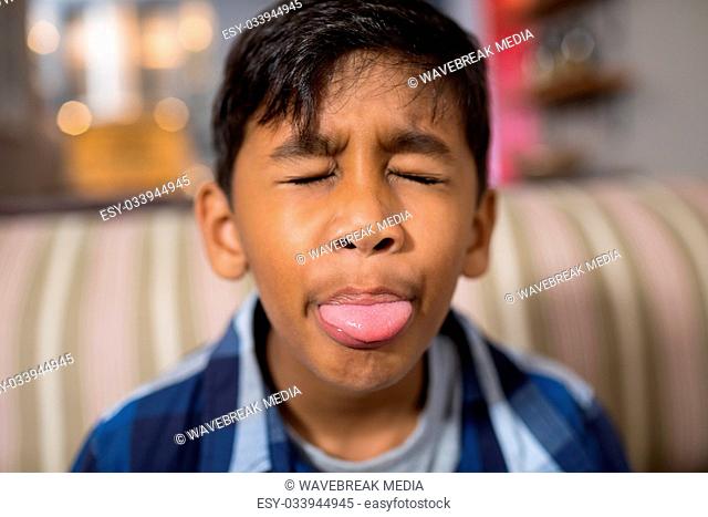 Close up of boy sticking out tongue
