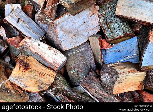 Detailed close up texture of stacked firewood with annual rings in high resolution