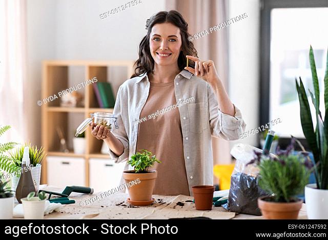 woman planting and fertilizing flowers at home