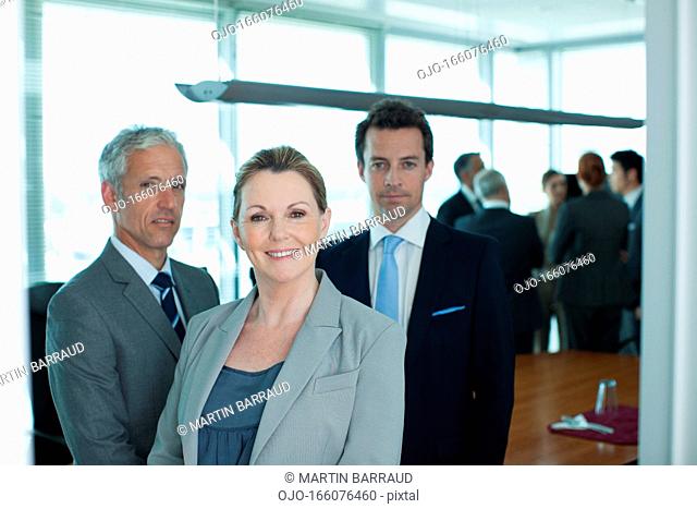 Portrait of smiling business people in conference room