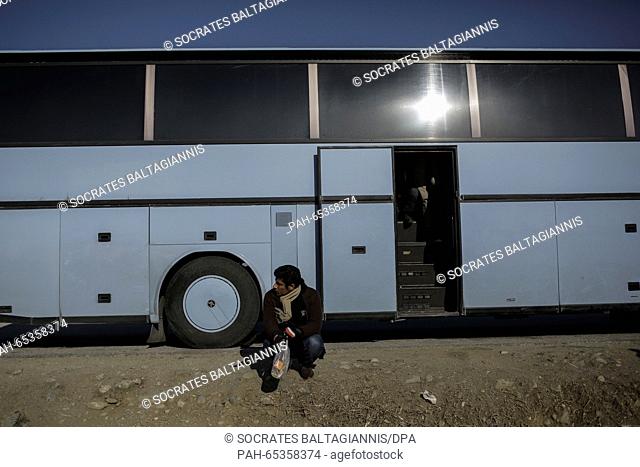 A migrant sits outside of a bus as he waits to cross the Greek-Macedonian border at Idomeni village, Greece, 25 January 2016
