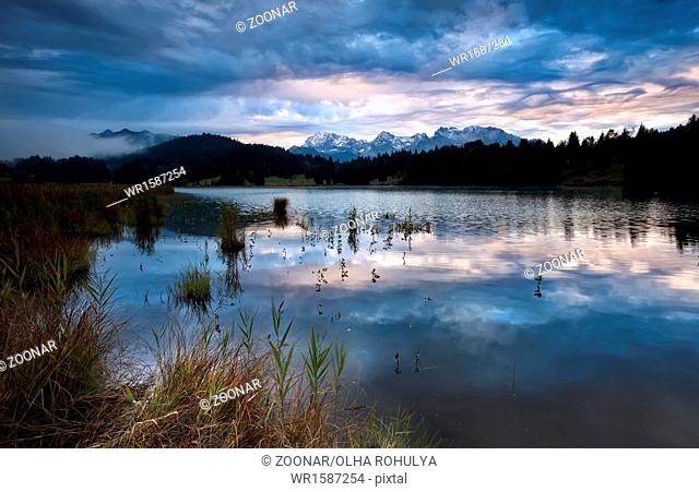 clouded sunrise over Geroldsee in Bavarian Alps