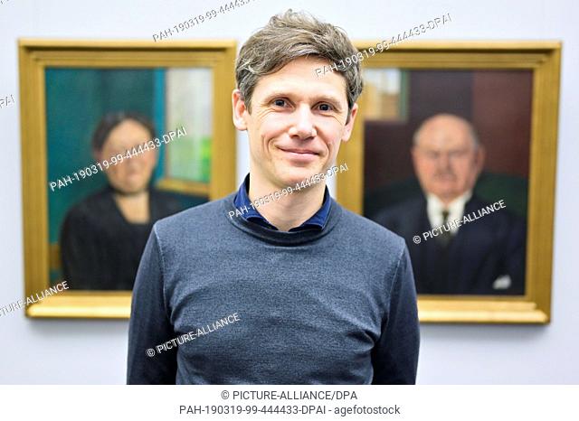 22 February 2019, Baden-Wuerttemberg, Mannheim: Provenance researcher Mathias Listl stands in front of portraits of the artist Wladimir von Zabotin by Sofie and...
