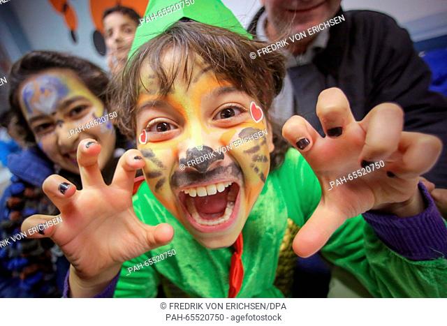 A young girl from Syria with a painted face participating in an information event on the carnival tradition in an accomodation for refugees in Mainz, Germany