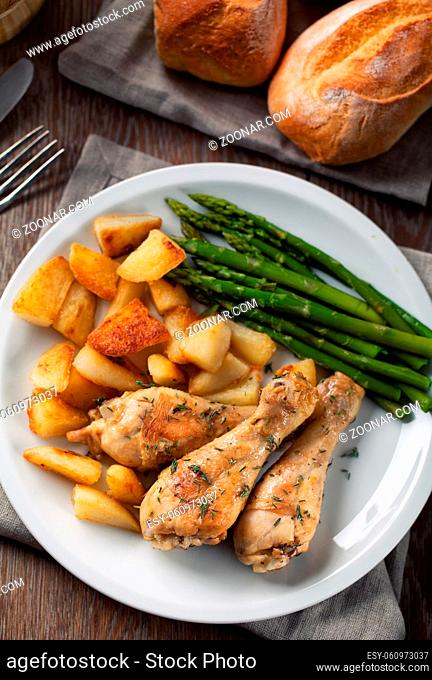 Roast chicken with potatoes and asparagus. High quality photo