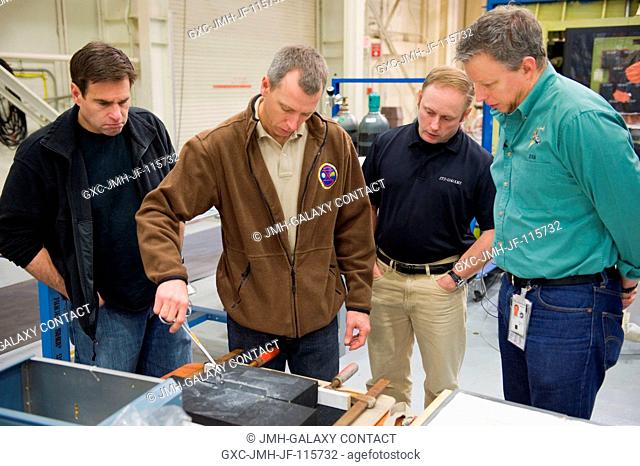 NASA astronauts Greg Chamitoff (left), Andrew Feustel and Michael Fincke, all STS-134 mission specialists, participate in an EVA tile repair training session in...