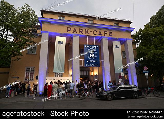 26 June 2023, Bavaria, Munich: Guests stand outside Munich's Park Café at the UFA reception. The film production company celebrated with many celebrities as...