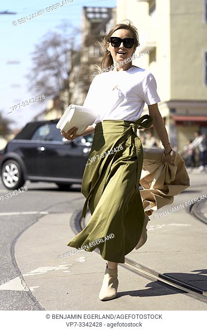 stylish woman running at street in city, in Munich, Germany