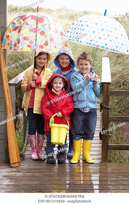 Children posing with umbrella