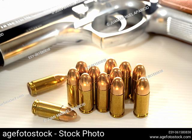 9mm bullets and gun at background