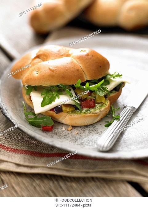 A sandwich filled with peppers, rocket and halloumi