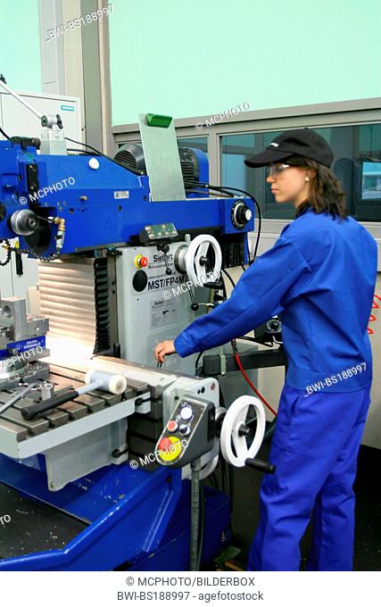 female apprentice working with machine
