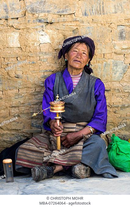Woman with prayer wheel at the monastery Mindrolling