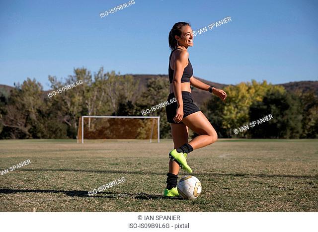 Woman on football pitch playing football