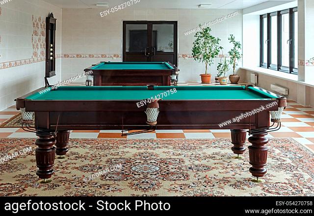 Beautifully decorated billiard room with mahogany pool tables